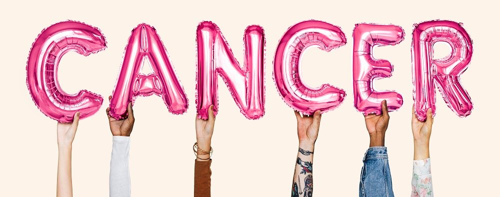 Multiple hands holding pink balloon letters spelling the word “CANCER,” symbolising awareness, support and early detection of urologic cancers treated in Indore by Dr. Pritesh Shrimali, best urologist in Indore.